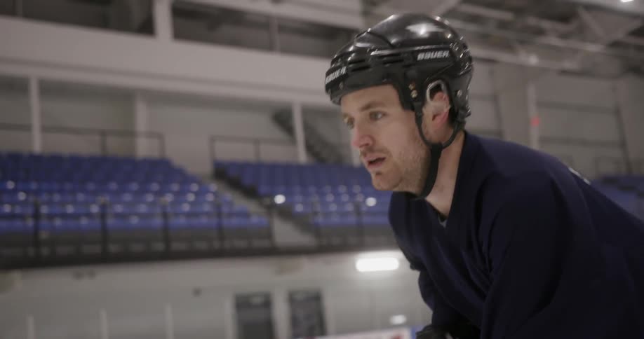 A man in a helmet in a skating rink