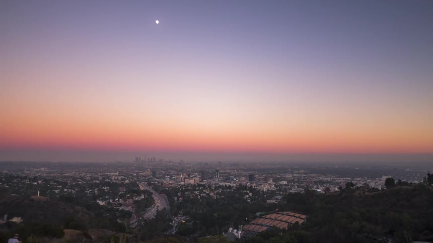 Panorama of a metropolis during the day and getting dark in timelapse