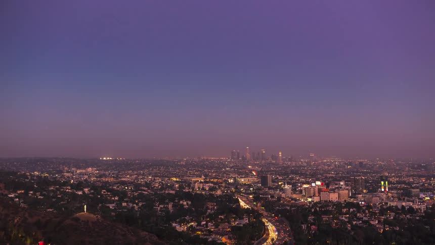 Skyline of a city with a highway with heavy traffic during the day