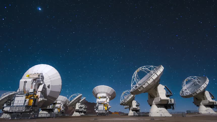 Panorama of scientific antenna pointed at the sky observing in timelapse the day darkens in stars