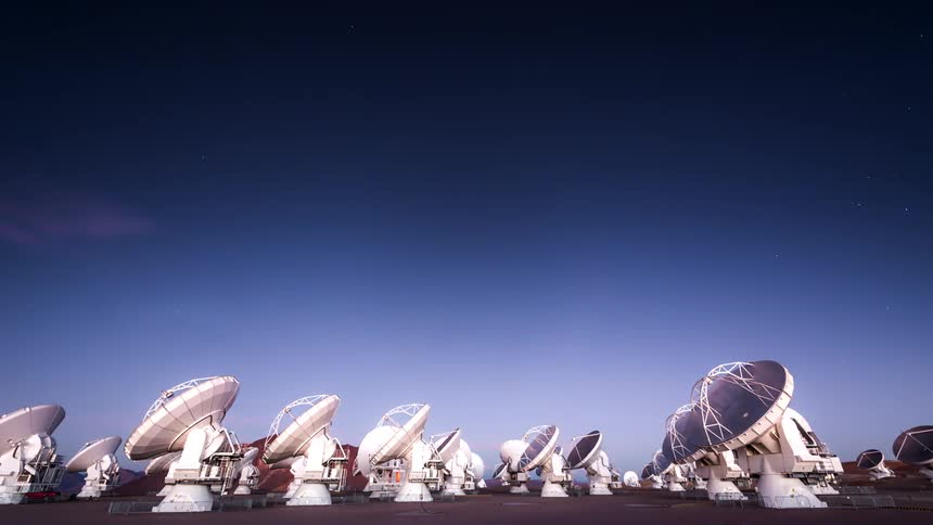 Space antennas on the ground pointed at the sky in time lapse on a dawning day
