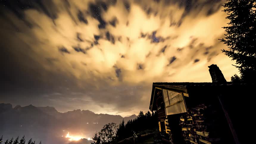 A cabin in the forest during the starry night