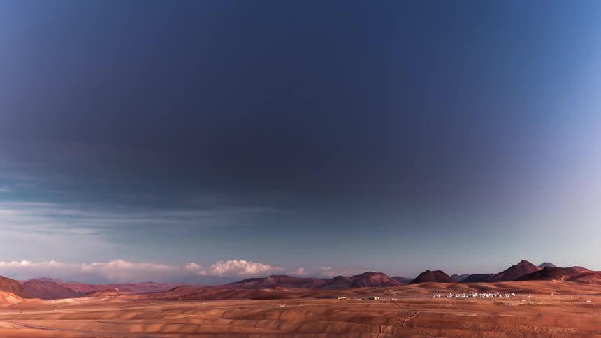 Time passes over buildings in a desert area