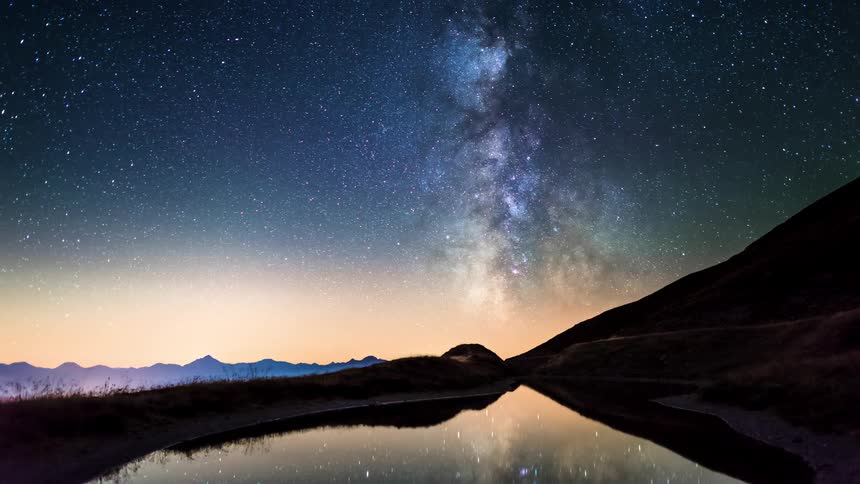 The milky way flows over the mountains