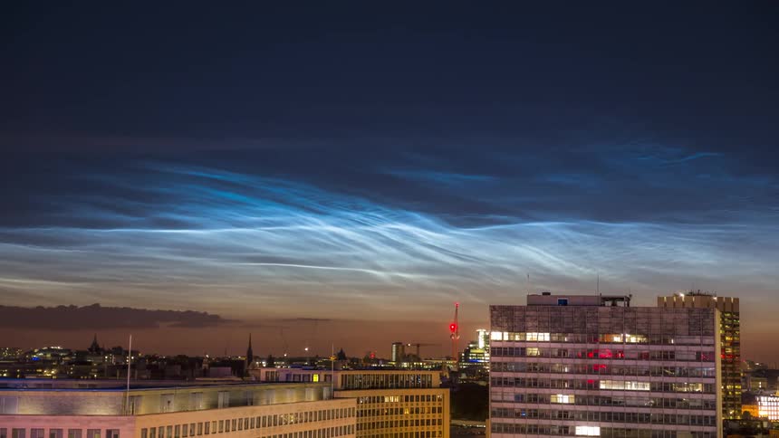 Panorama of buildings in a metropolis with blue and red sky in timelapse