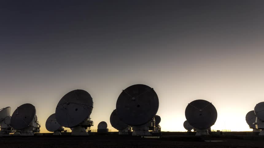 Panorama of scientific antenna pointed at the moving sky with a guide dimming and dusk with stars