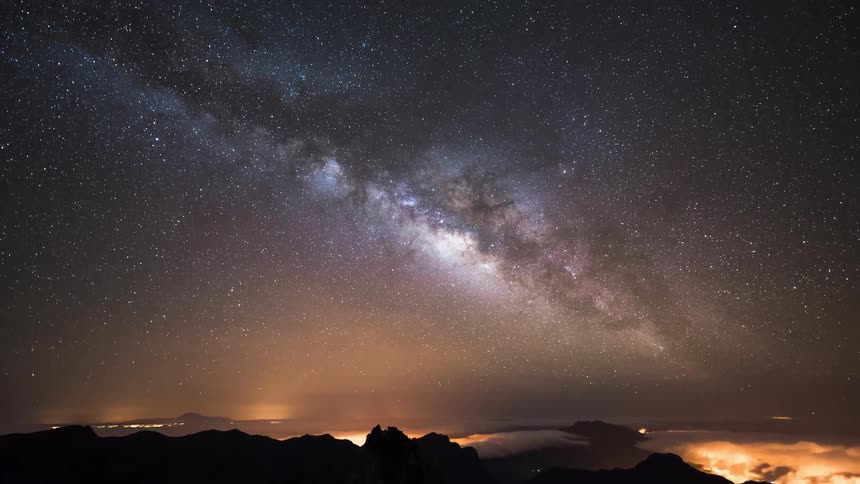 Silhouette of mountains and sky view with nebula and endless stars at night