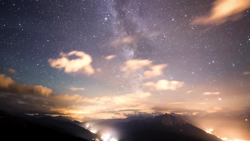 Panorama of mountain ranges and dawn sky in timelapse with clouds passing by