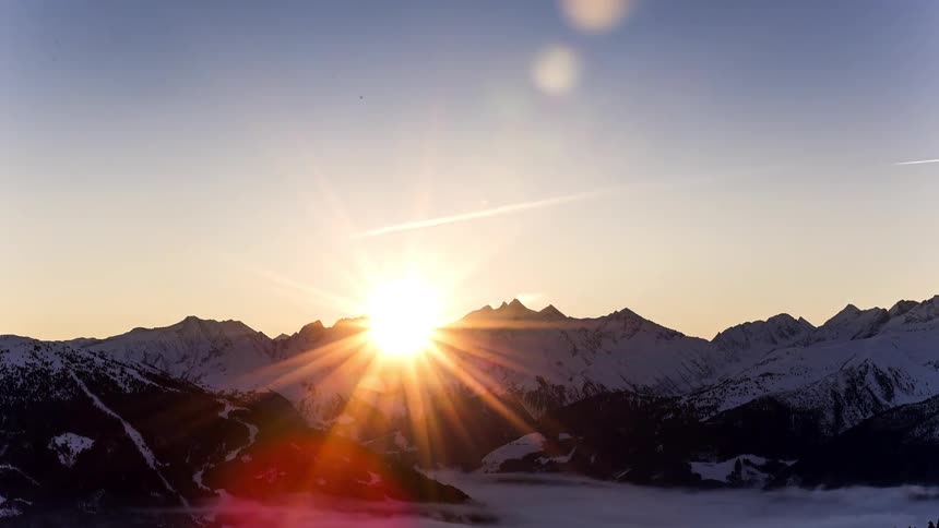 Aerial of a snowy mountain range in a valley during winter