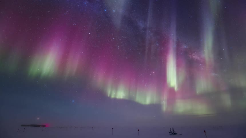 Landscape of a sky with purple and greenish Aurora Australis