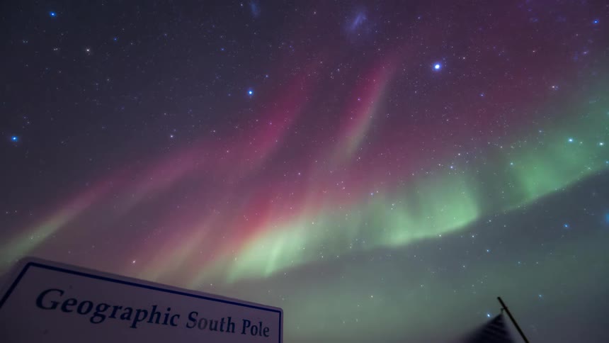Sign of the south pole with greenish and purple Aurora Australis