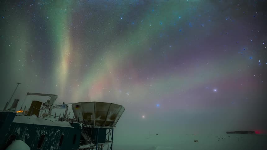 Scientific station at the south pole with a view of the sky with Aurora Australis