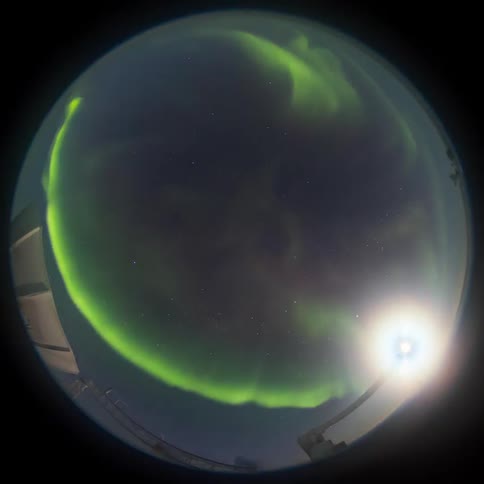fisheye view of aurora, moon and stars