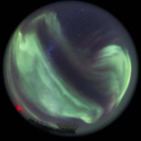 fisheye view of the Aurora Australis over an observatory