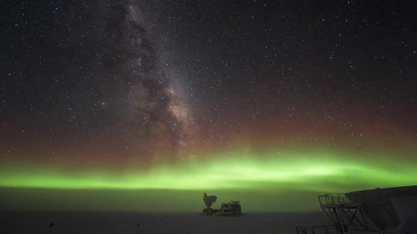 Aurora Australis floats through sky as stars rotates over an observatory