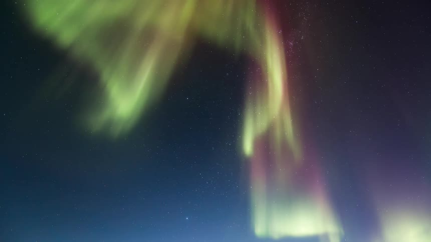 A colorful aurora in the sky at dusk or dawn