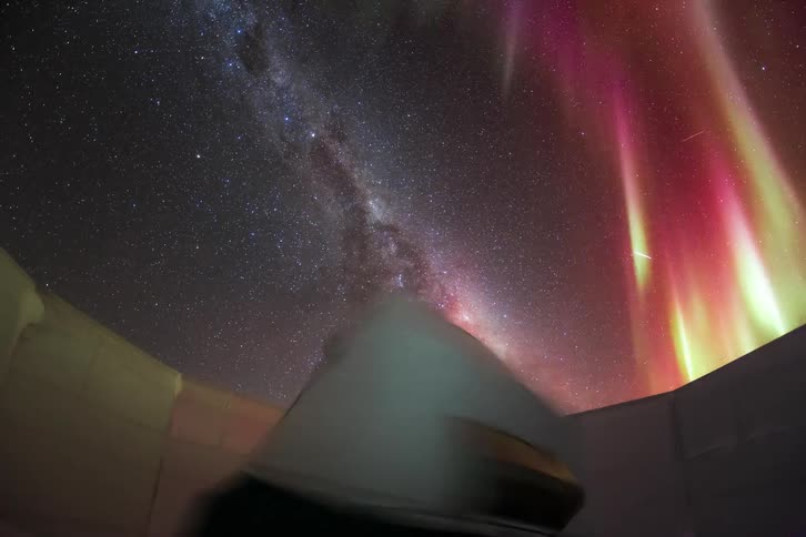 A telescope takes shots of space while an aurora and shooting stars fill the sky