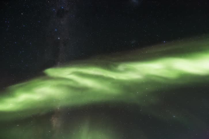 Aurora Australis shining on a starry sky