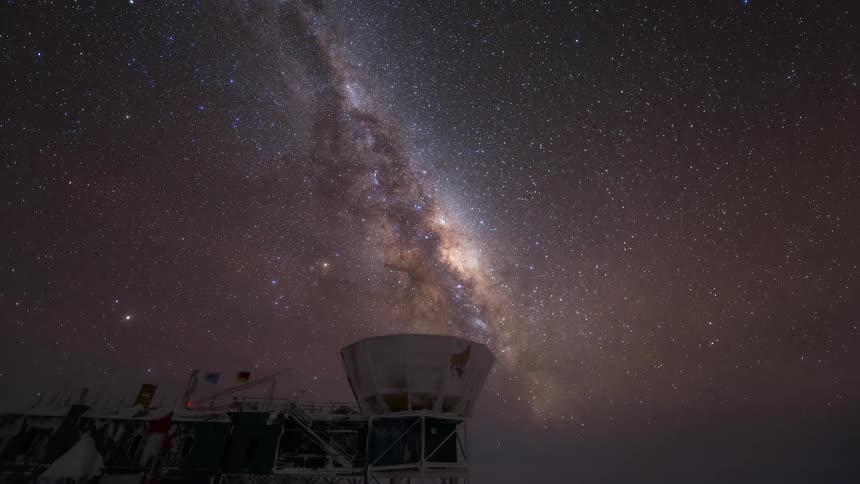 The milky way shines over the telescope