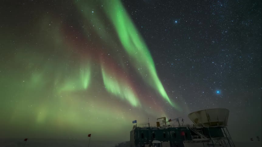 Aurora Australis and stars over an observatory