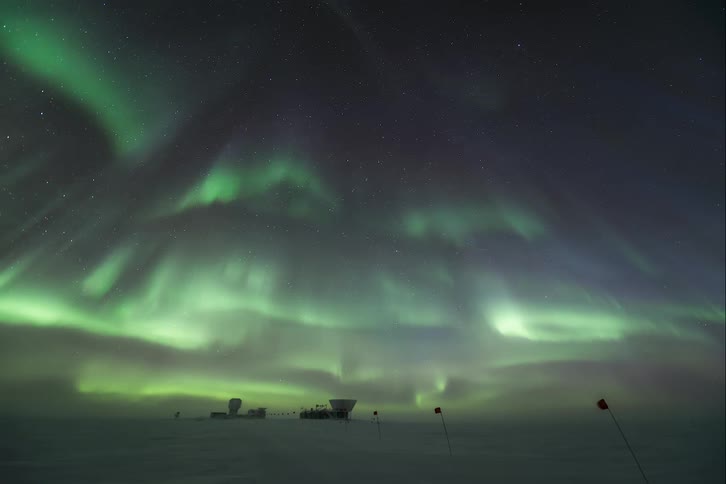 A huge aurora in the sky over an observatory