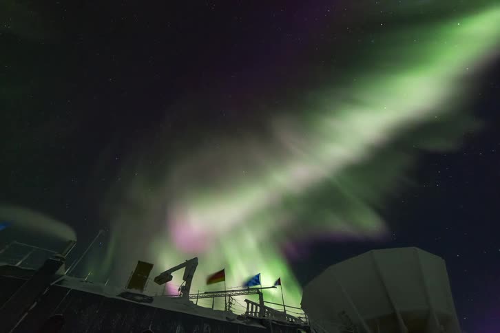 The Aurora Australis shine over an observatory