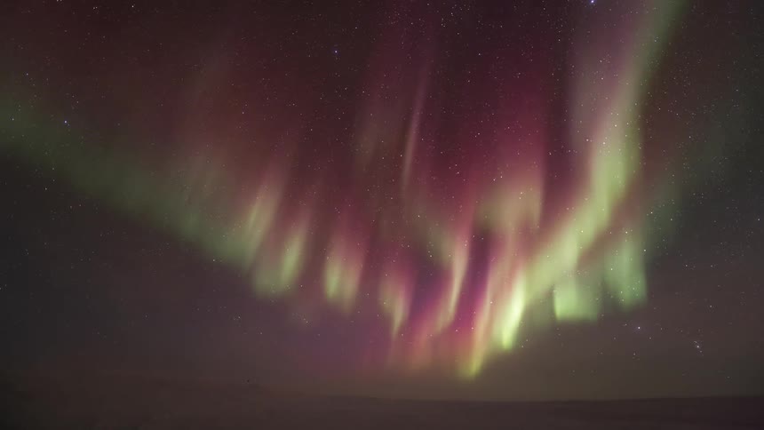 Starry sky landscape with greenish and purple Aurora Australis