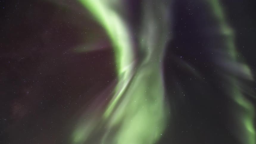 A bright green Aurora Australis in a starry sky