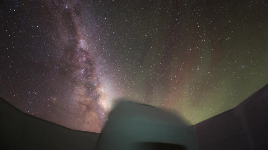A rotating telescope is facing the starry sky with Aurora Australis