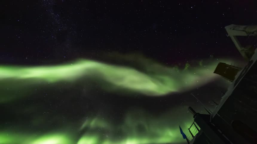 The Aurora Australis lights up the starry sky during the cold night