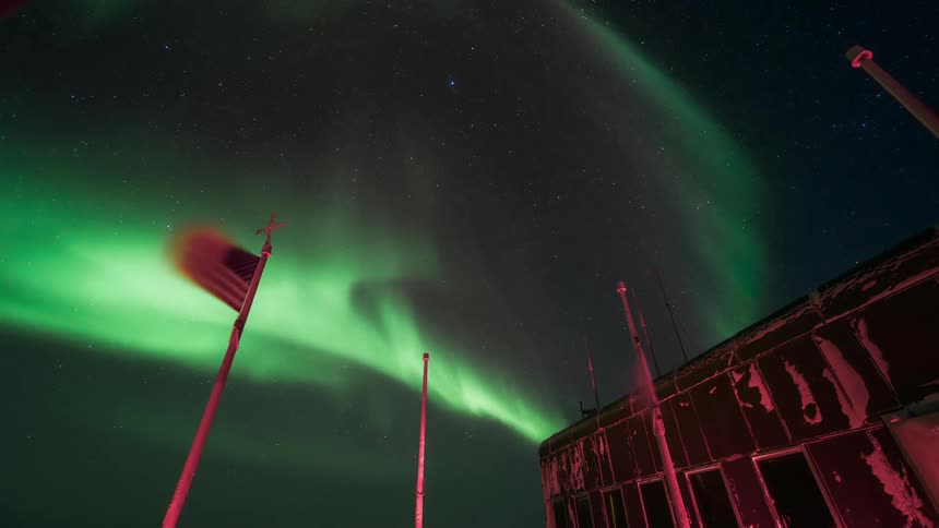 South Pole observatory overlooking the sky with Aurora Australis at night