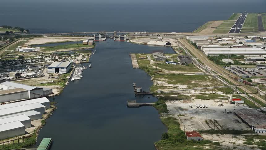 Aerial panorama of seaside airstrip and surrounding factories