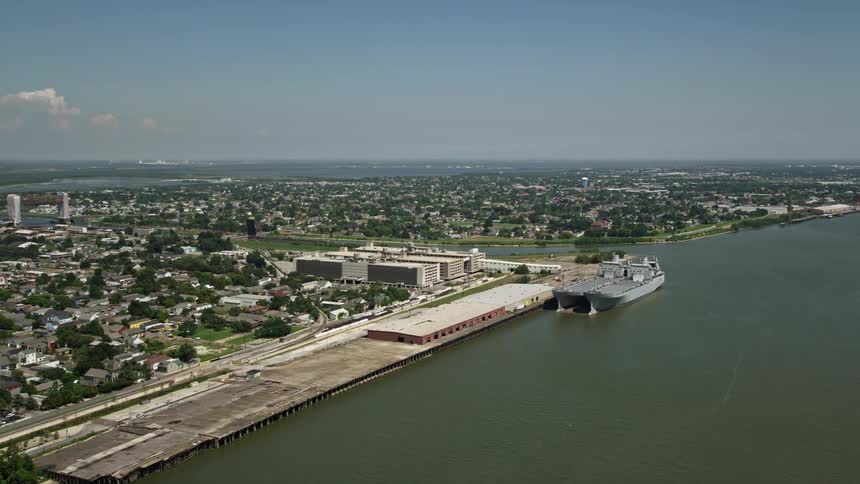 A cargo ship docked at a port in the city during the day