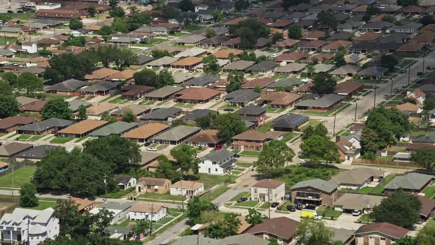 Houses in a suburb with trees and cars