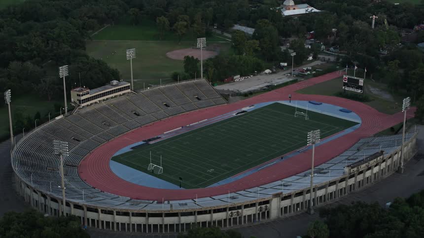 Aerial of a football field in a residential neighborhood during the day