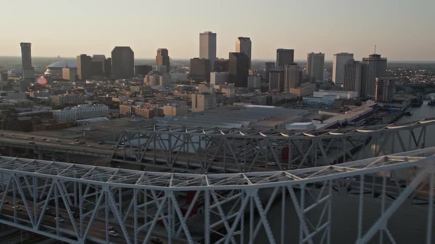 Aerial panorama of skyscrapers in a seaside metropolis with bridges in a morning sky