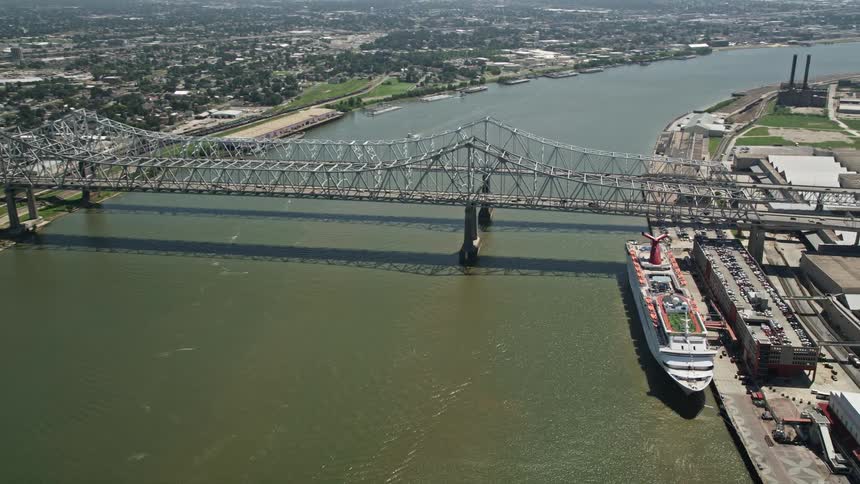 Aerial panorama of two bridges connecting cities over a canal with boats