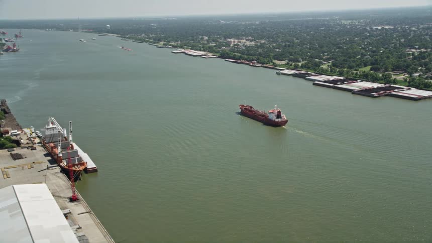 Cargo boat crossing a canal at sea in the middle of an urban city