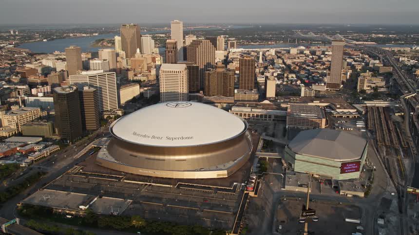 A stadium with a white dome in a city