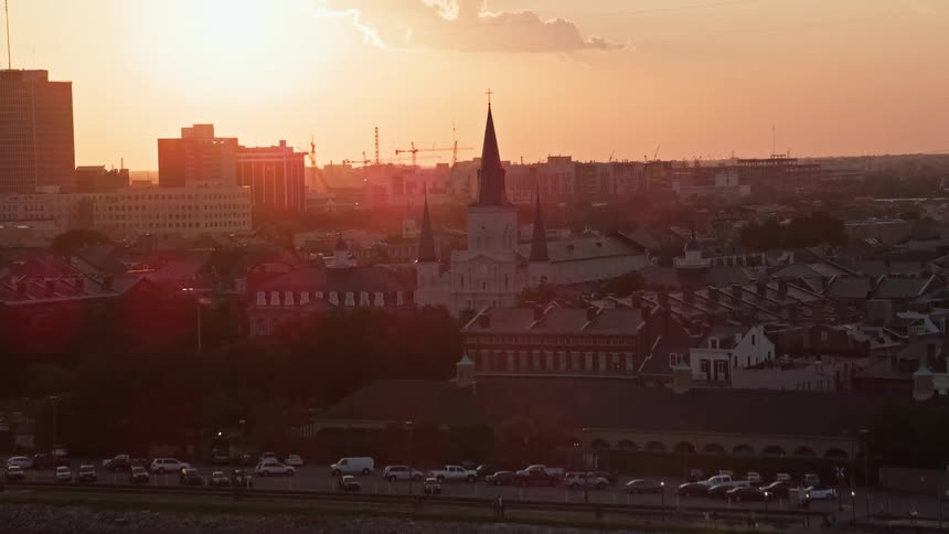 Panorama of a metropolitan city by the sea with a cathedral and reddish late afternoon sky