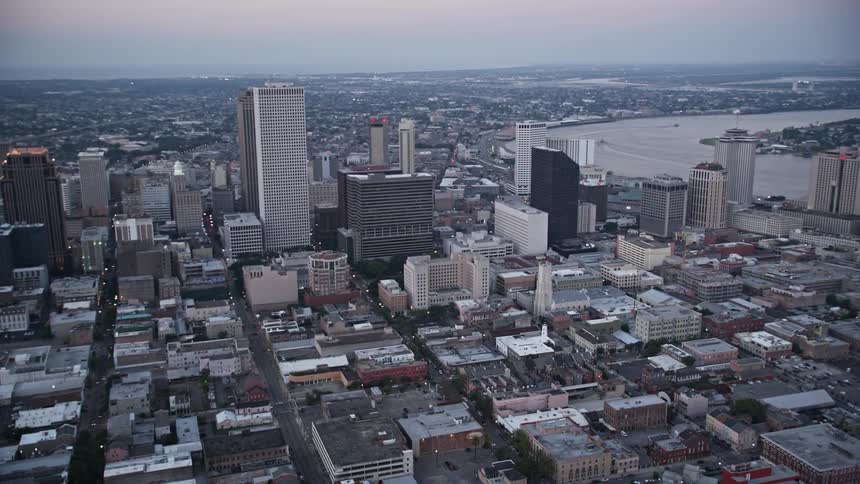 Aerial panorama of a metropolis with skyscrapers by the sea and in the late afternoon