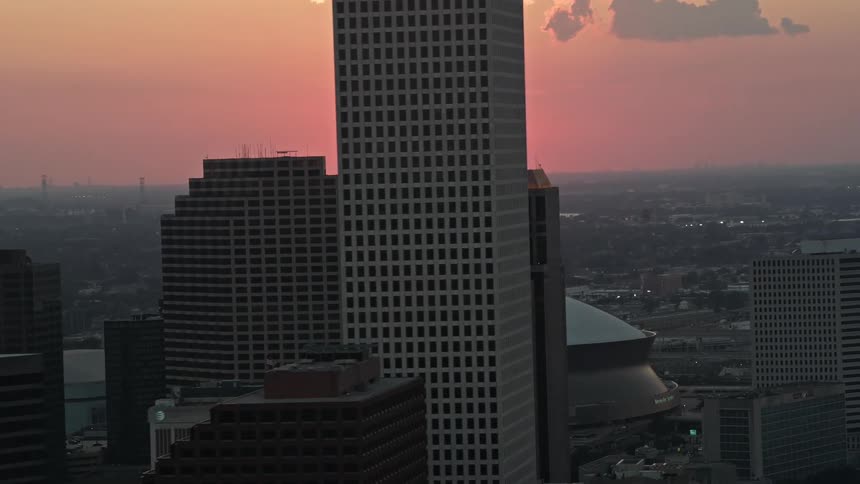 Aerial panorama of large buildings in the middle of a metropolis with the reddish soil on the horizon