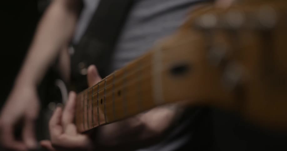 Close up view of a person playing a guitar