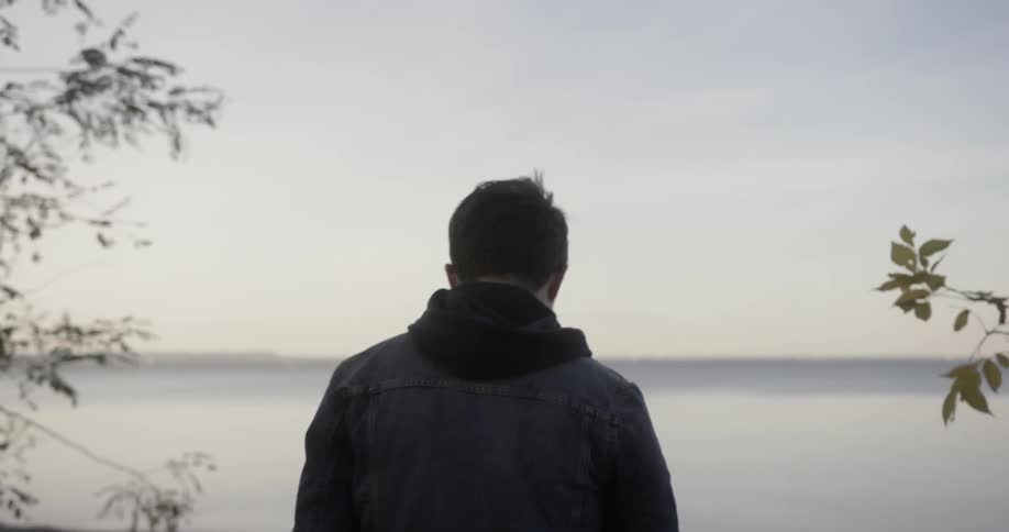 A man approaches the shoreline