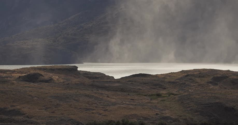 strong winds moving gusts of spray over a lake