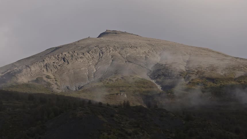 A mountain sits behind a ridge