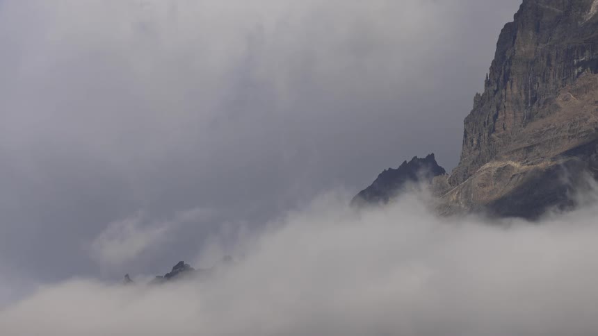 A clip of a mountain covered with fog