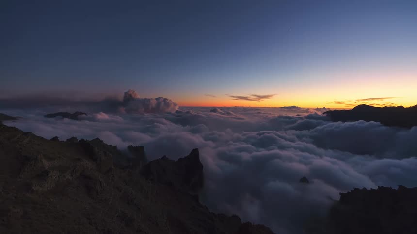 Panorama of mountains covered by clouds during dusk