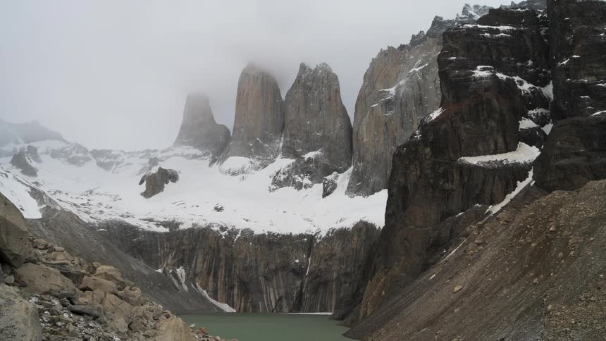 Snow covered mountain areas near a lake