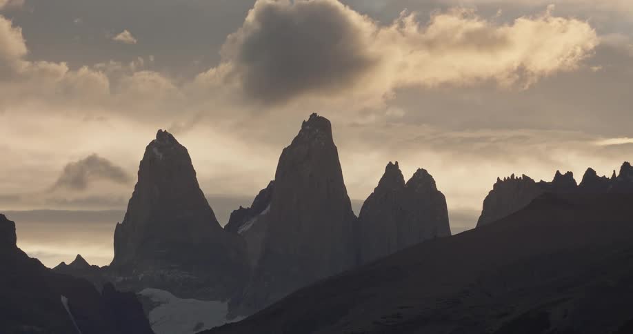 Large clouds move over a mountain range